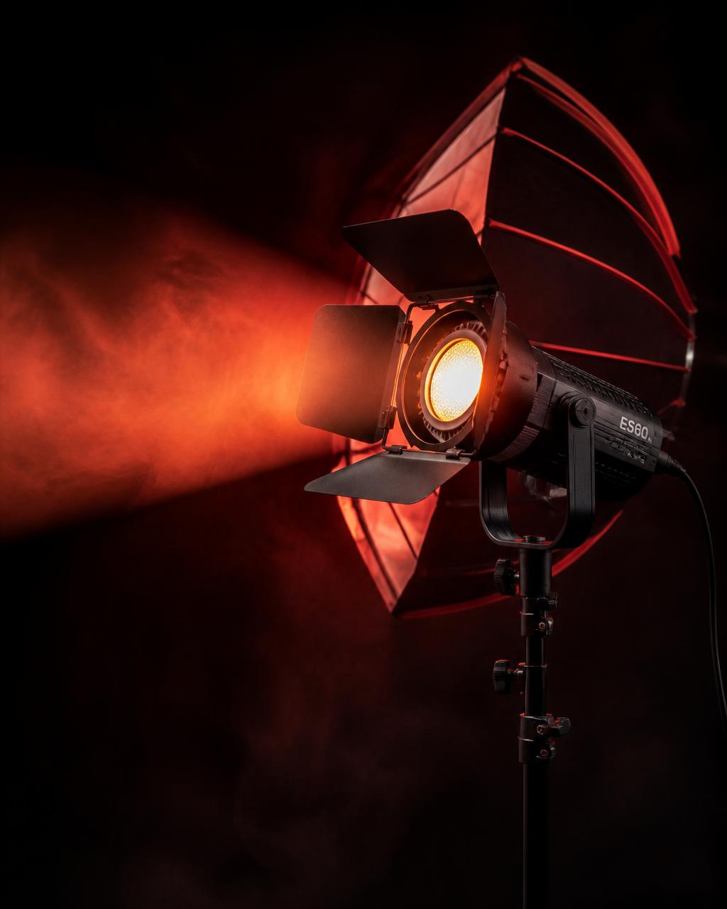 Professional studio light with red beam in a dark studio